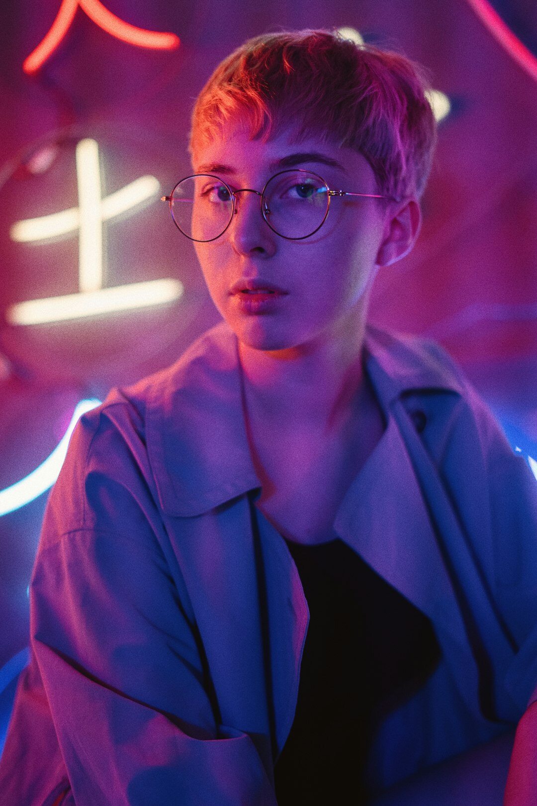 Portrait of a Swiss video editor wearing glasses in a small editing studio